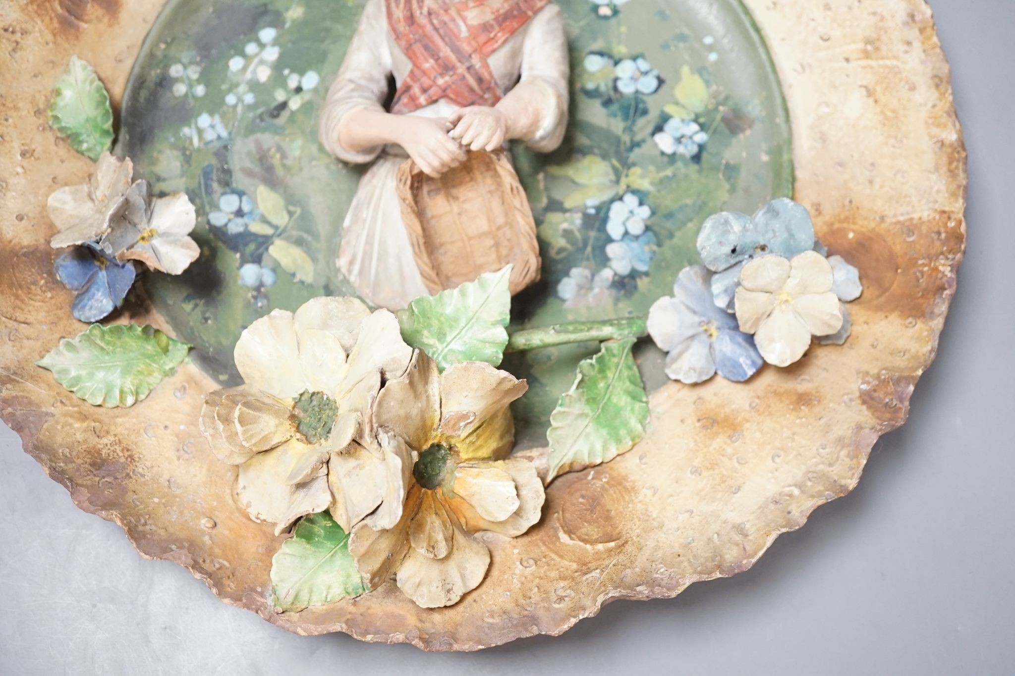 A Continental terracotta wall plaque and a Poutney & Co plaque (2) 39cm